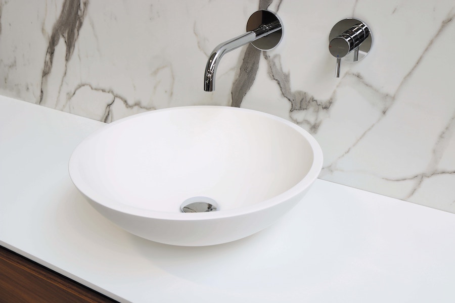 A white sink with a tap